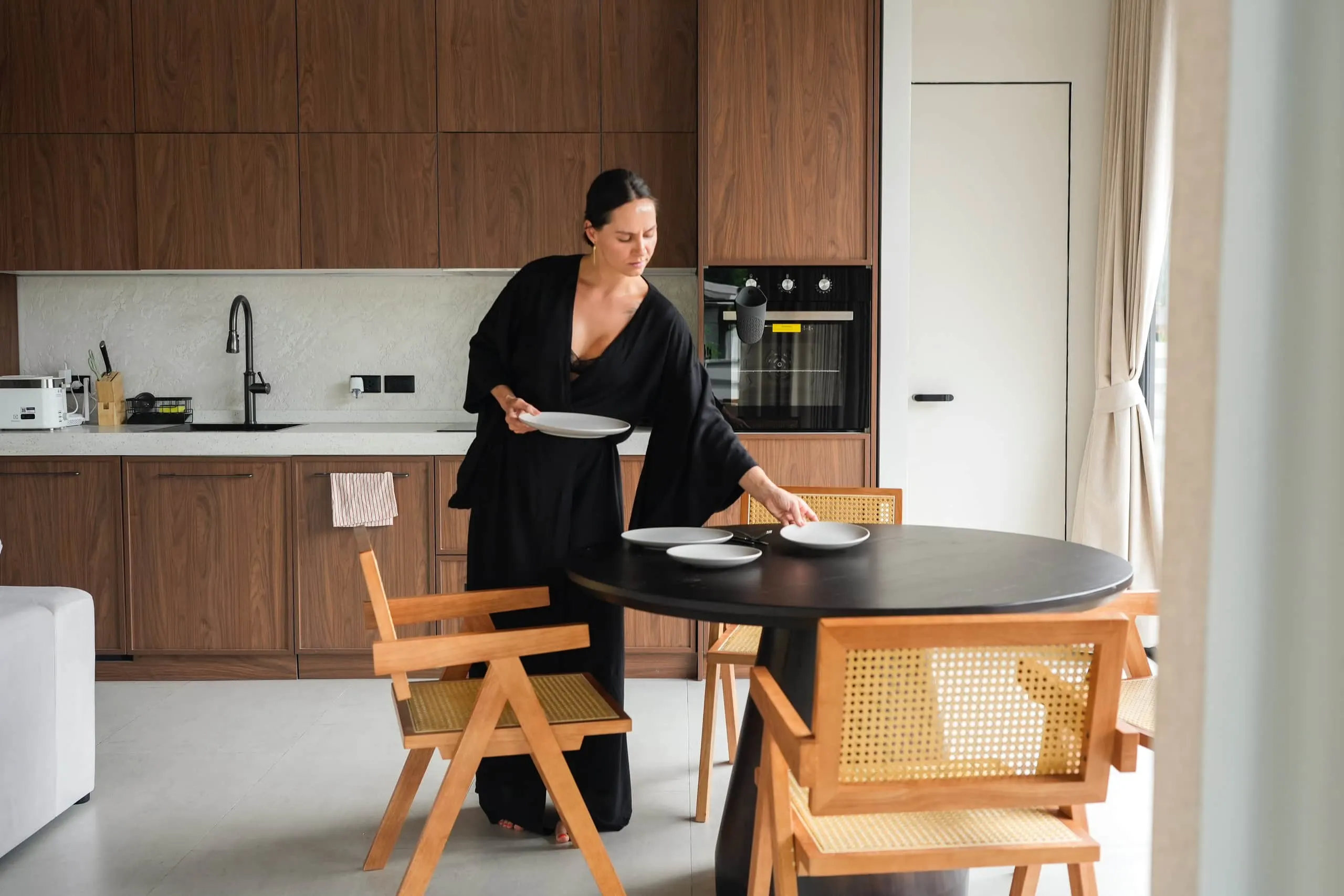 Villa II — setting the round dining table by the kitchen
