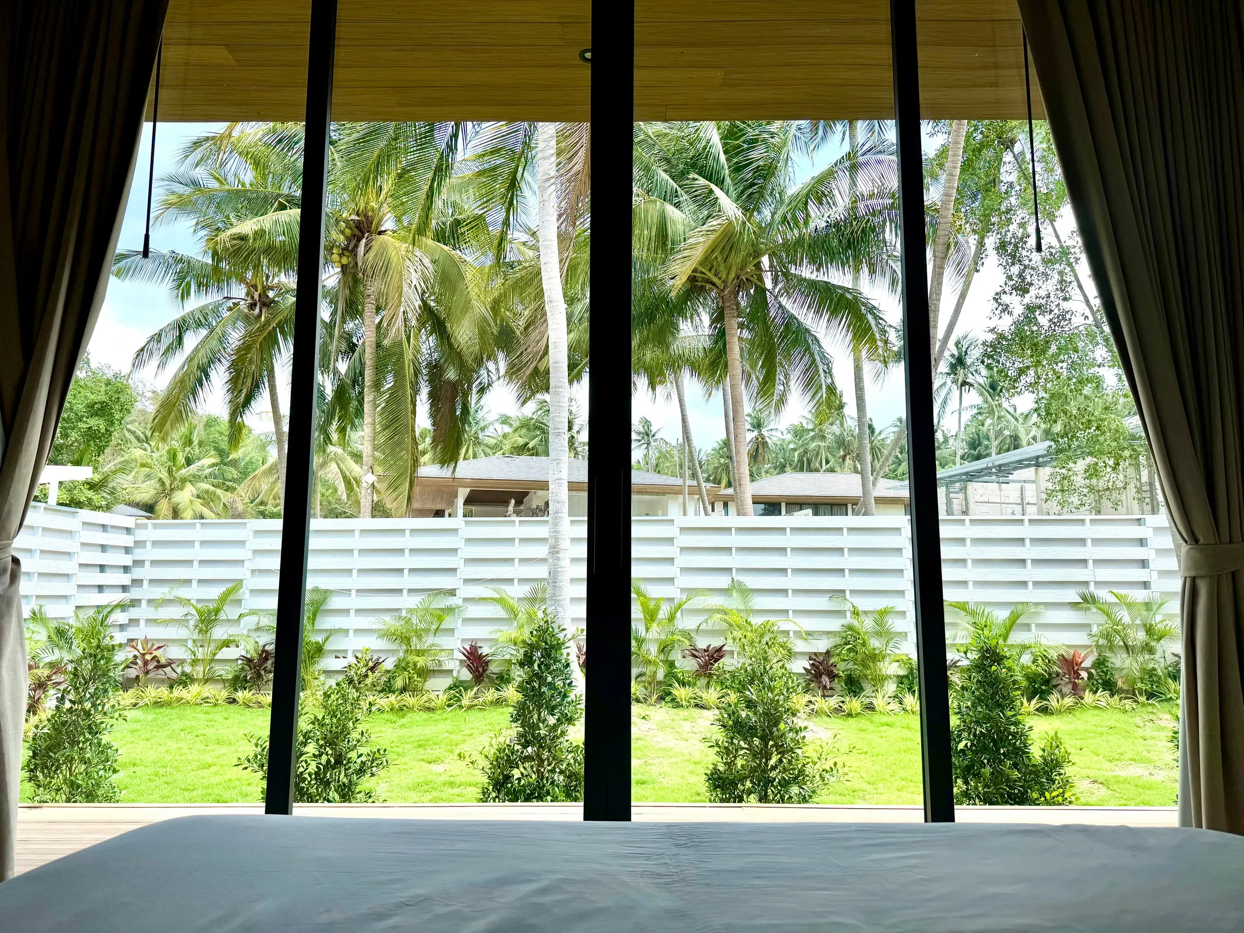 Villa I — bedroom one, teak slat headboard with warm hidden lighting