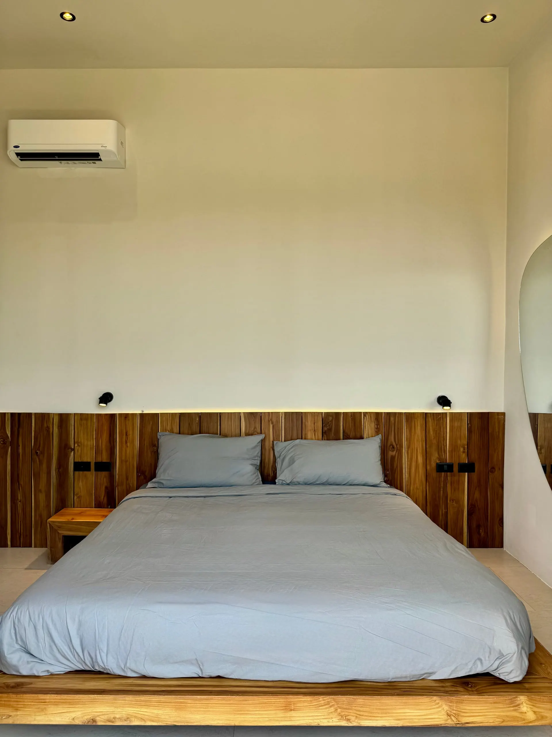 Villa I — bedroom two, bed with blue linens and reading lights