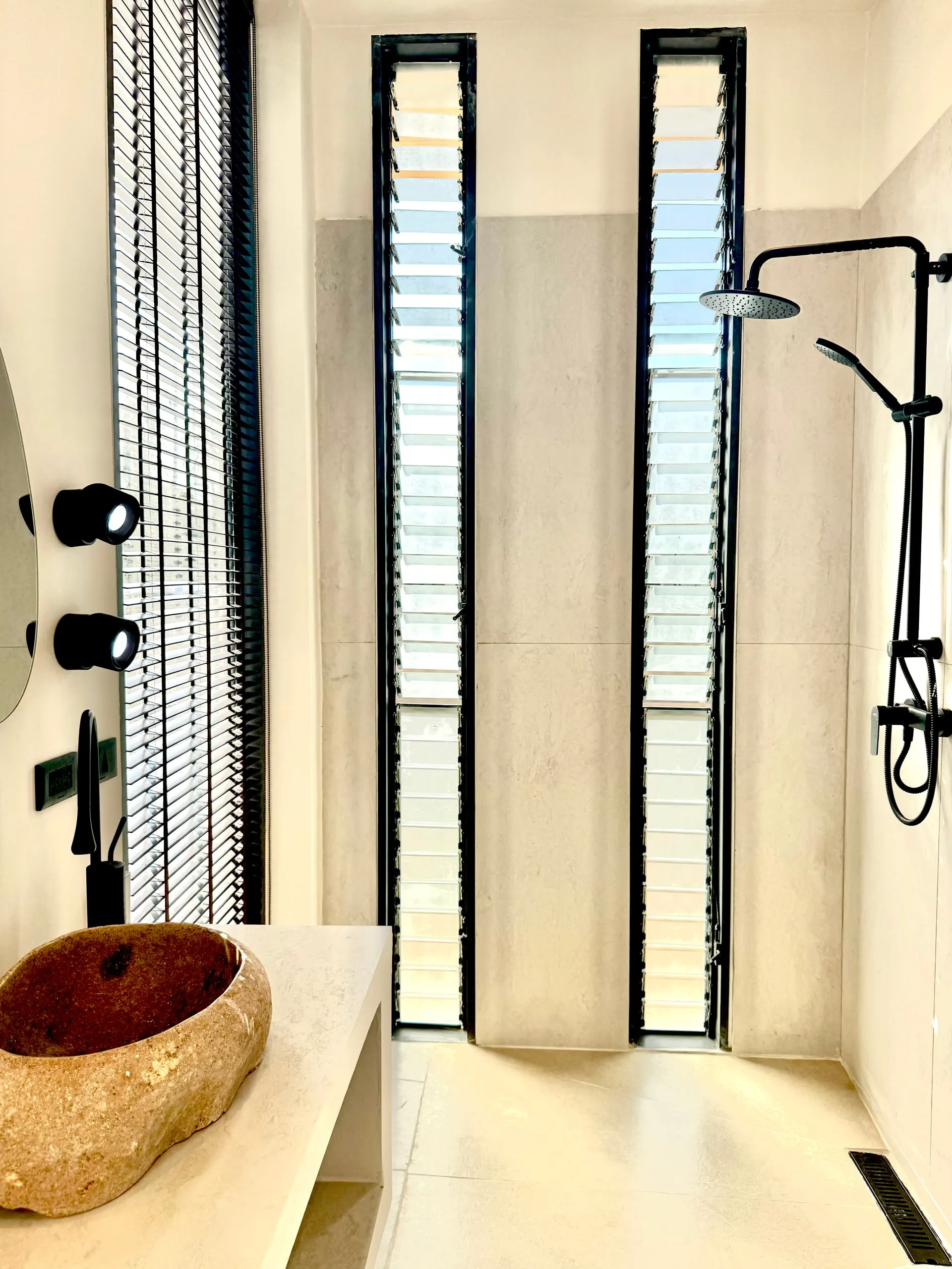 Villa II — bathroom one, basin and black rain-shower column