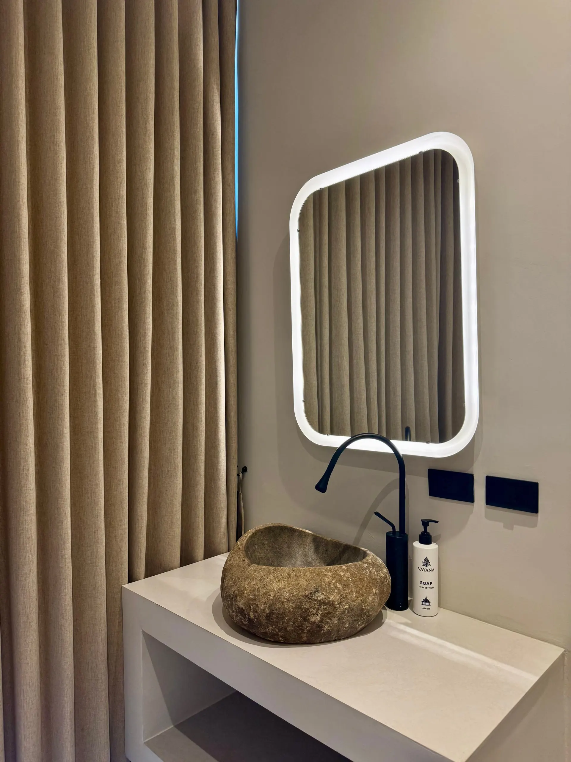 Villa I — bathroom two, stone sink and backlit mirror