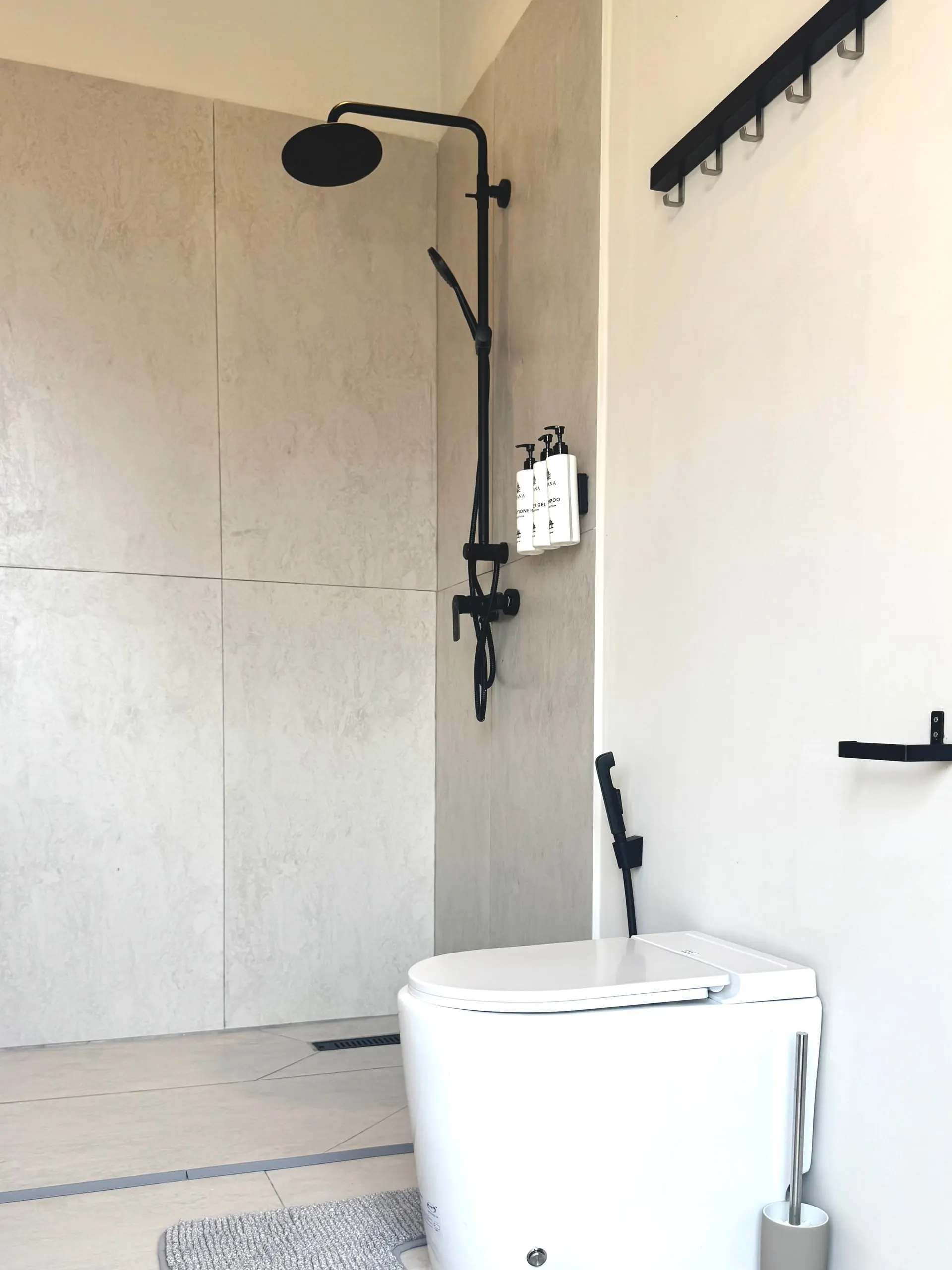 Villa I — bathroom two, rain shower and toilet zone