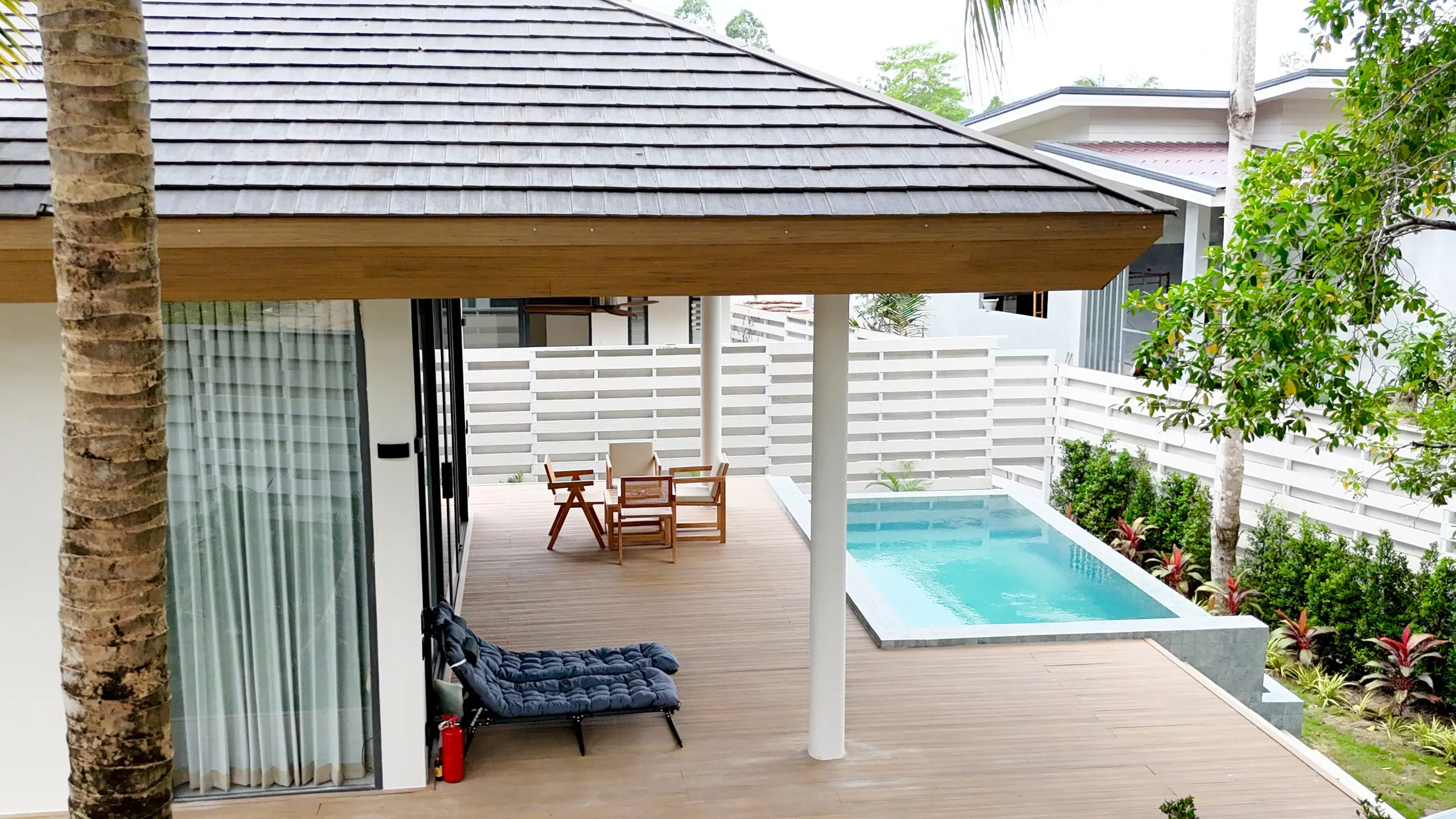 Villa II — terrace from above: pool, teak seating and blue lounger